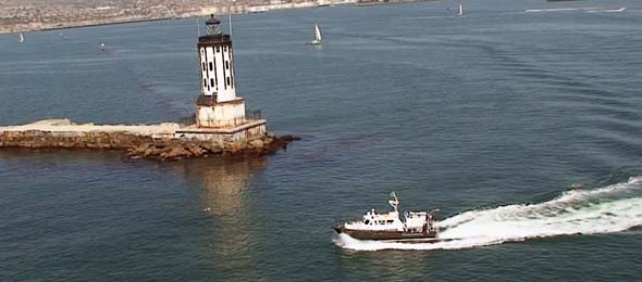 <em>Clearwater</em> and lighthouse