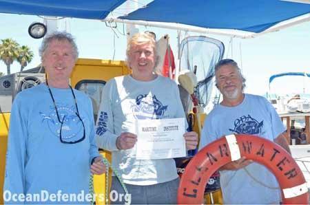 Onboard the <em>Clearwater</em> in dock: Jim Lieber, Kurt Lieber, and Jeff Connor celebrate Kurt’s new “Master 100 Tons” captain’s license.