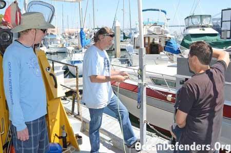 Onboard the <em>Clearwater</em> in dock: Jeff Connor, Jim Lieber, and Billy Arcila learning how to tie knots.