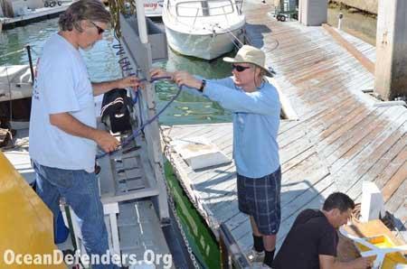 Onboard the <em>Clearwater</em> in dock: Jeff Connor, Jim Lieber, and Billy Arcila working on the boat.