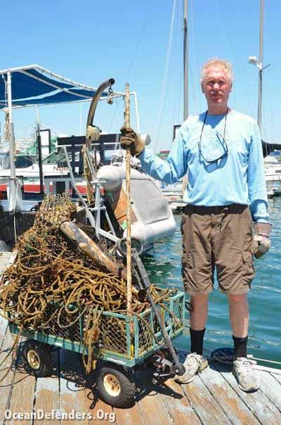 Jim Lieber stands next to some of the marine debris pulled from an area just outside of the LA Harbor Lighthouse.