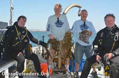 Chris Bell, Kurt Lieber, John Krieger, and Al Laubenstein on the back of the <em>Clearwater</em> with today's haul of marine debris.