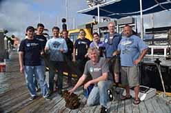 ODA Dive & Boat Crew with net at slip - left to right: Shingo Ishida, Andy The, Eric Humphreys, Steve Millington, Jeff Connor, Lyndsey, Jim Lieber, Mike Jessen, and in front Kurt Lieber.
