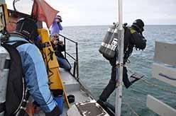 ODA volunteer divers Eric Humphreys and Shingo Ishida enteringwater