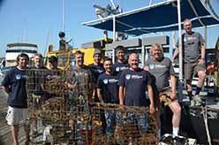 ODA Dive & Boat Crew with the retrieved, abandoned lobster traps at dockside of the <em>Clearwater</em> boat