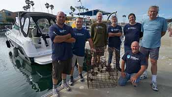 ODA Dive & Boat Crew at dock wit reclaimed lobster trap