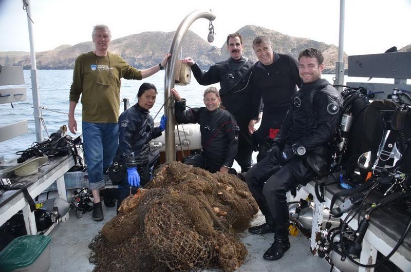 ODA Volunteer Dive Crew proudly display the abandoned squid net they removed, making the ocean more safe for wildlife!