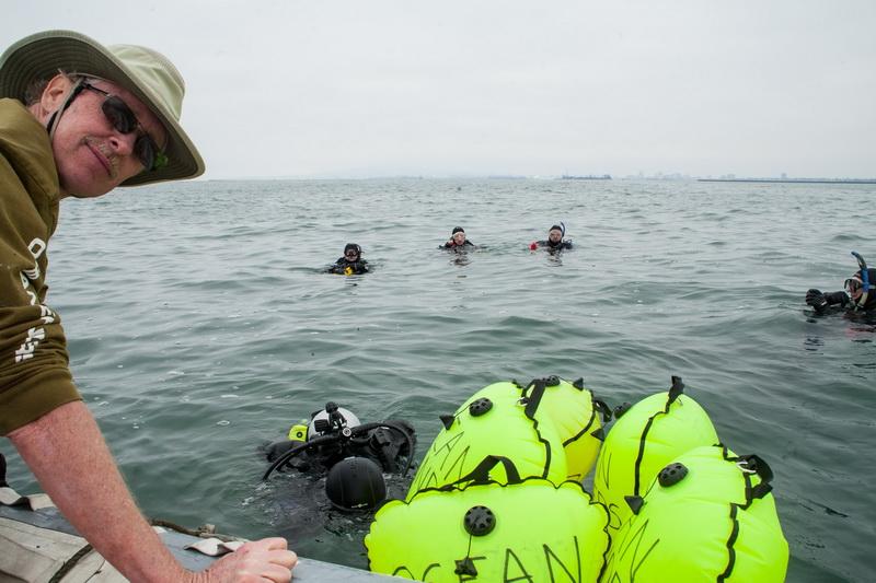 ODA volunteer divers in water with Rigid Inflatable Boat (RIB) and lift bags