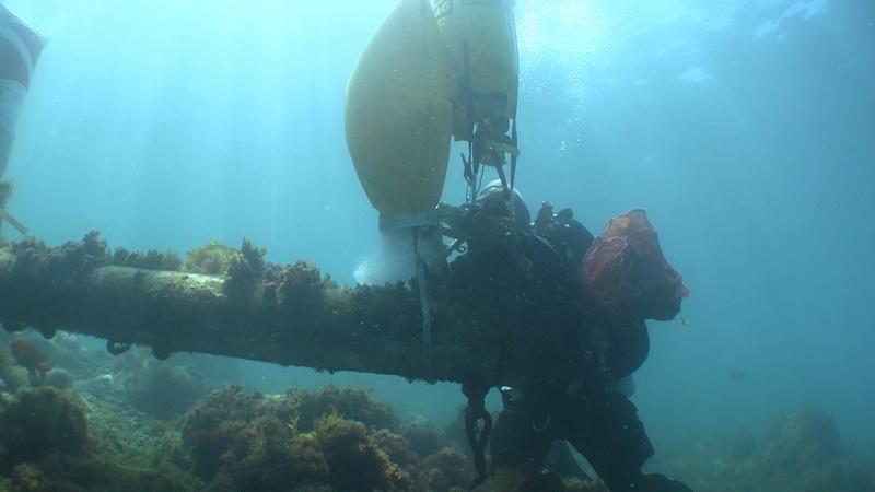 ODA Volunteer Diver Kim Cardena attaching lift bag to sunken wreck's mast