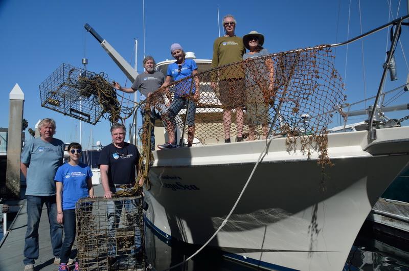 A happy crew with hauled-out marine debris