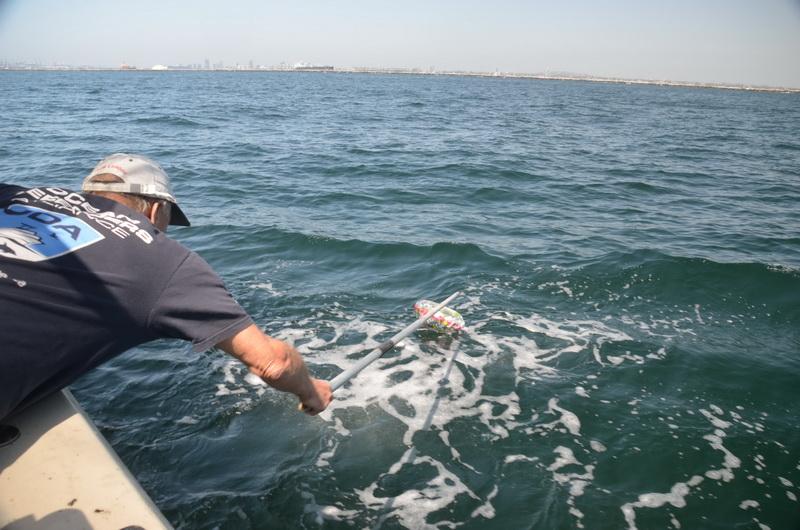 Ocean Defender volunteer Dave Merrill cleans the ocean of pollution