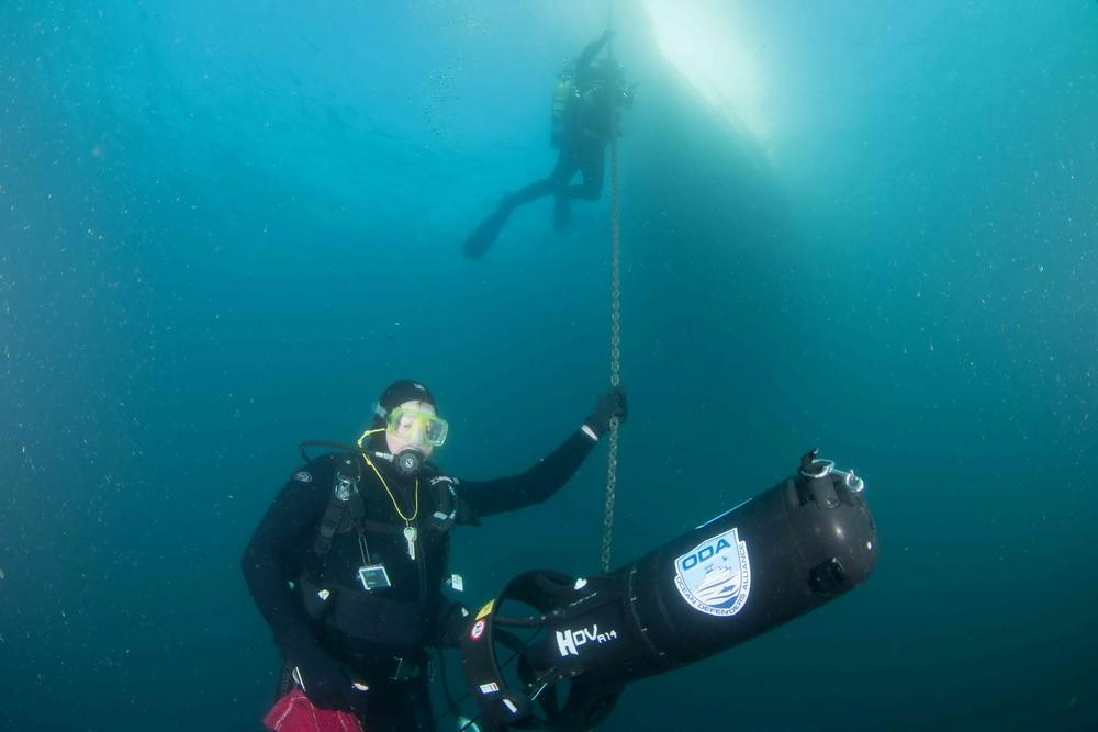 ODA Dive Team member Jim McKeeman with scooter on chain