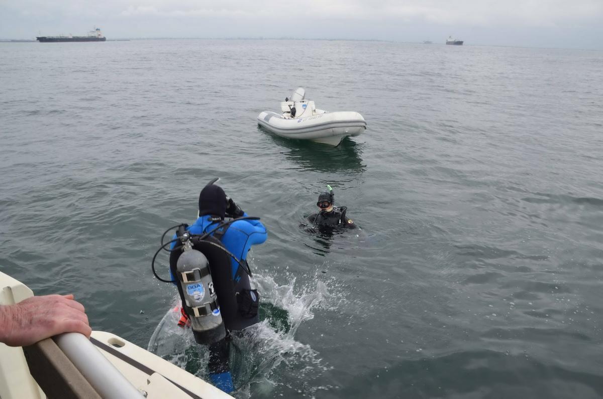 Dive crew retrieve debris