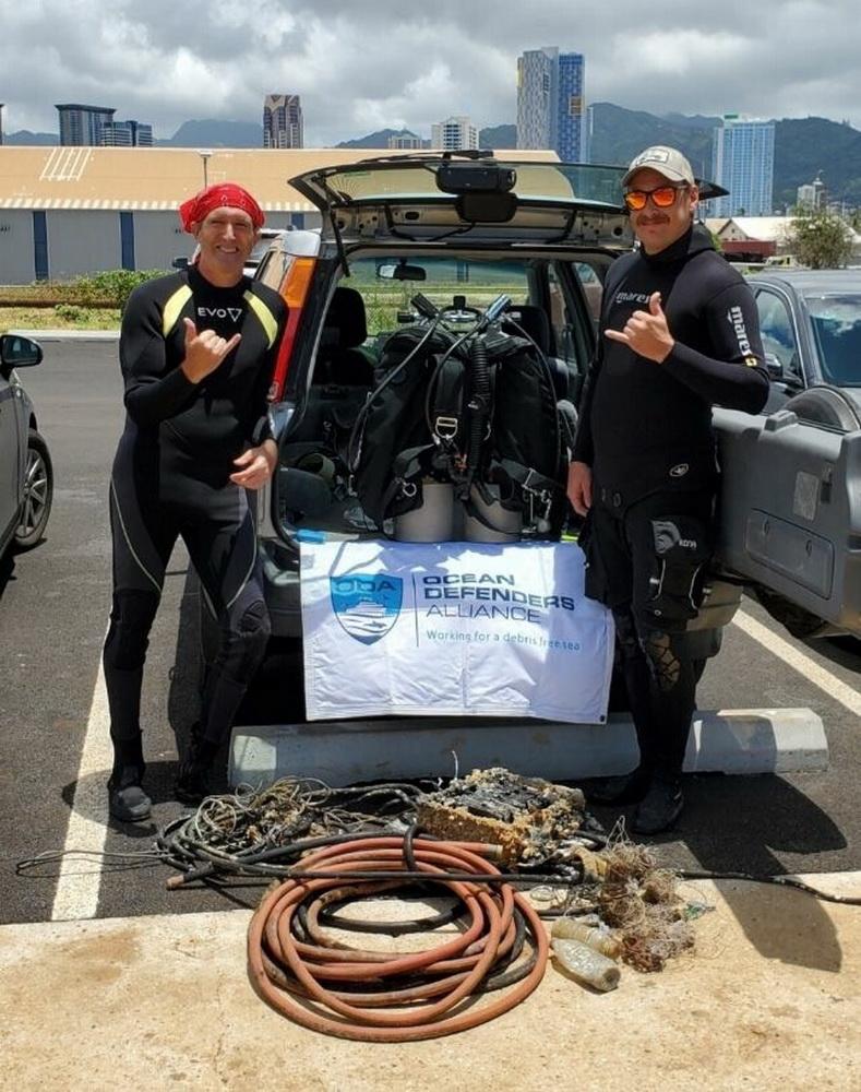 ODA Divers Glenn and Ed display the abandoned gear they removed