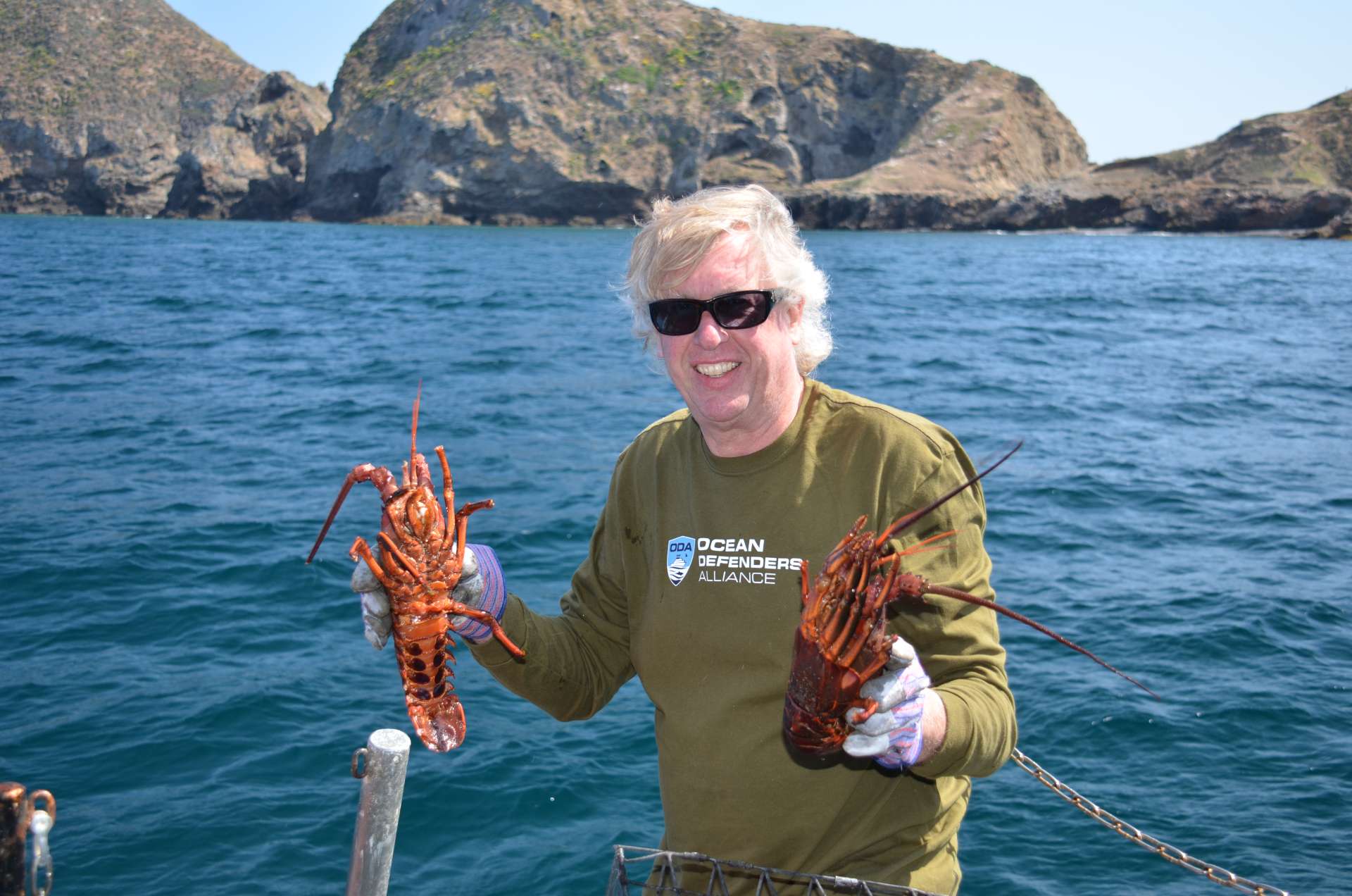 Captain Kurt releasing 2 lobsters 
