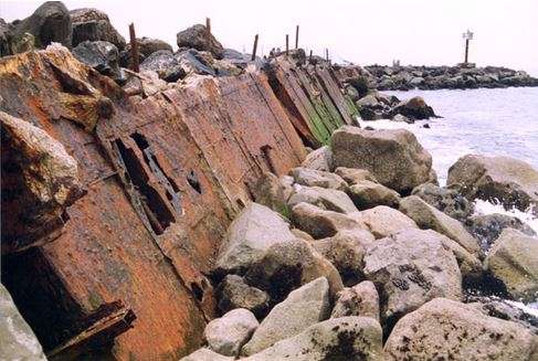 Pieces of the La Janelle mixed in with the breakwall. With permission from WreckSite.