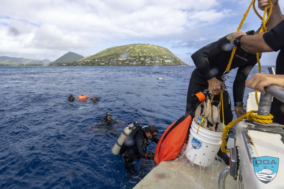 Divers at surface with hauled out ghost gear