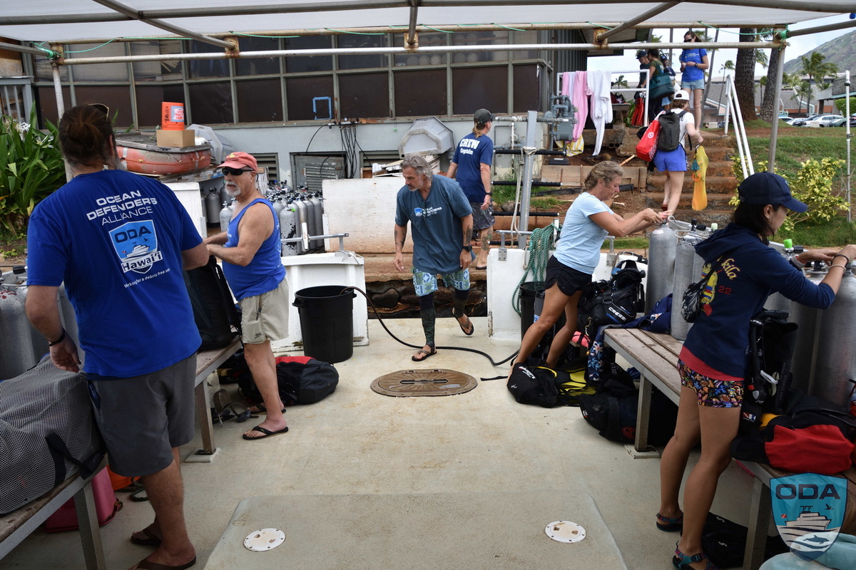 Crew members get gear ready for the cleanup expedition