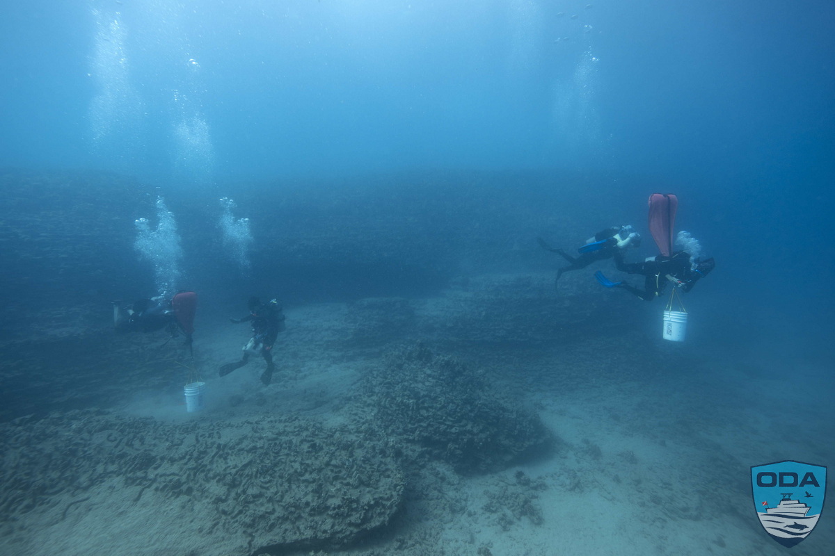 Divers removing debris underwater