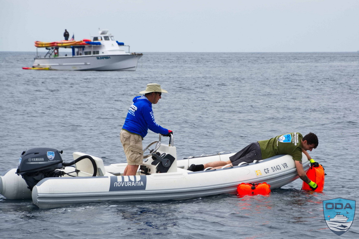 RIB crew retrieves lobster trap sent to the surface