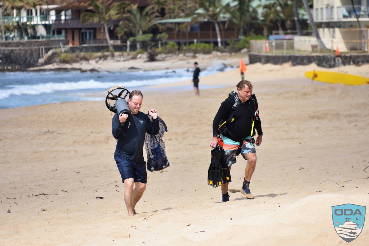 Divers exiting water after hauling out a variety of trash in the ocean